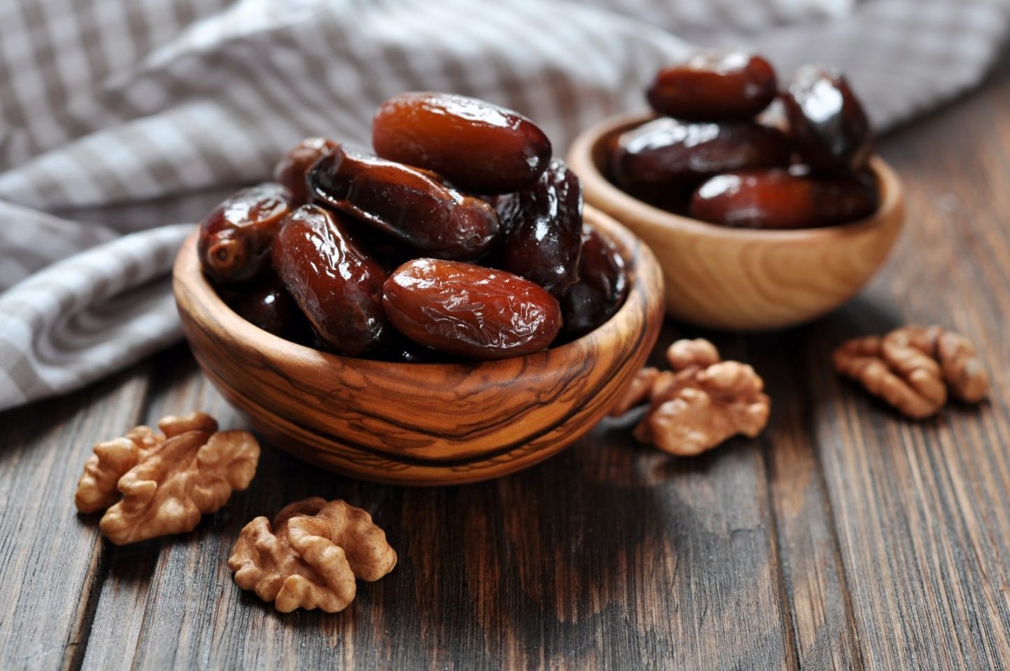 Persian dates in wooden bowls with walnuts